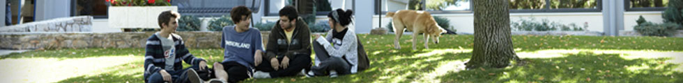 Students sitting on campus lawn